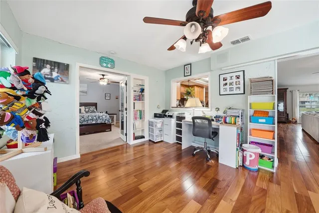 an aerial view of residential houses with outdoor space and trees