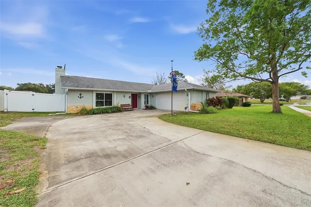 a living room with furniture kitchen view and a window