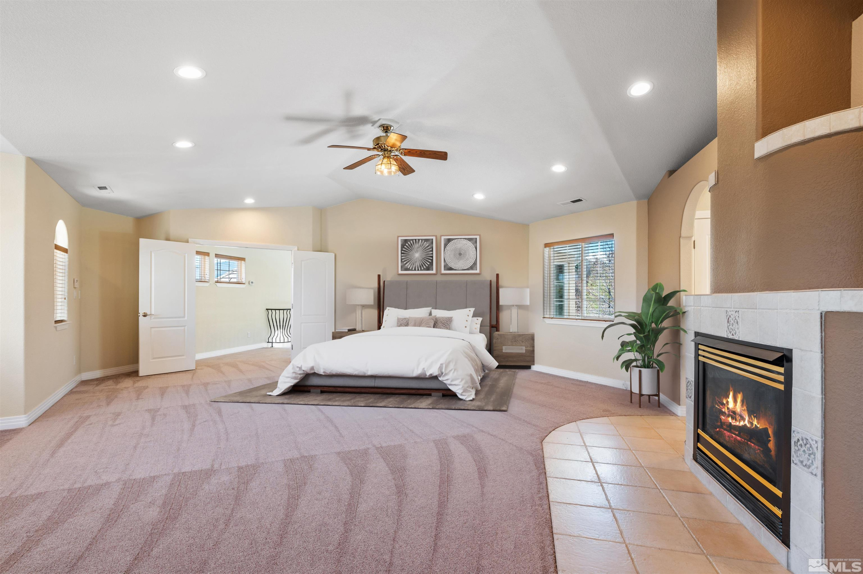 14535 South Quiet Reno, NV 89511 - Photo 20 of 40 a spacious bedroom with a large bed and a chandelier