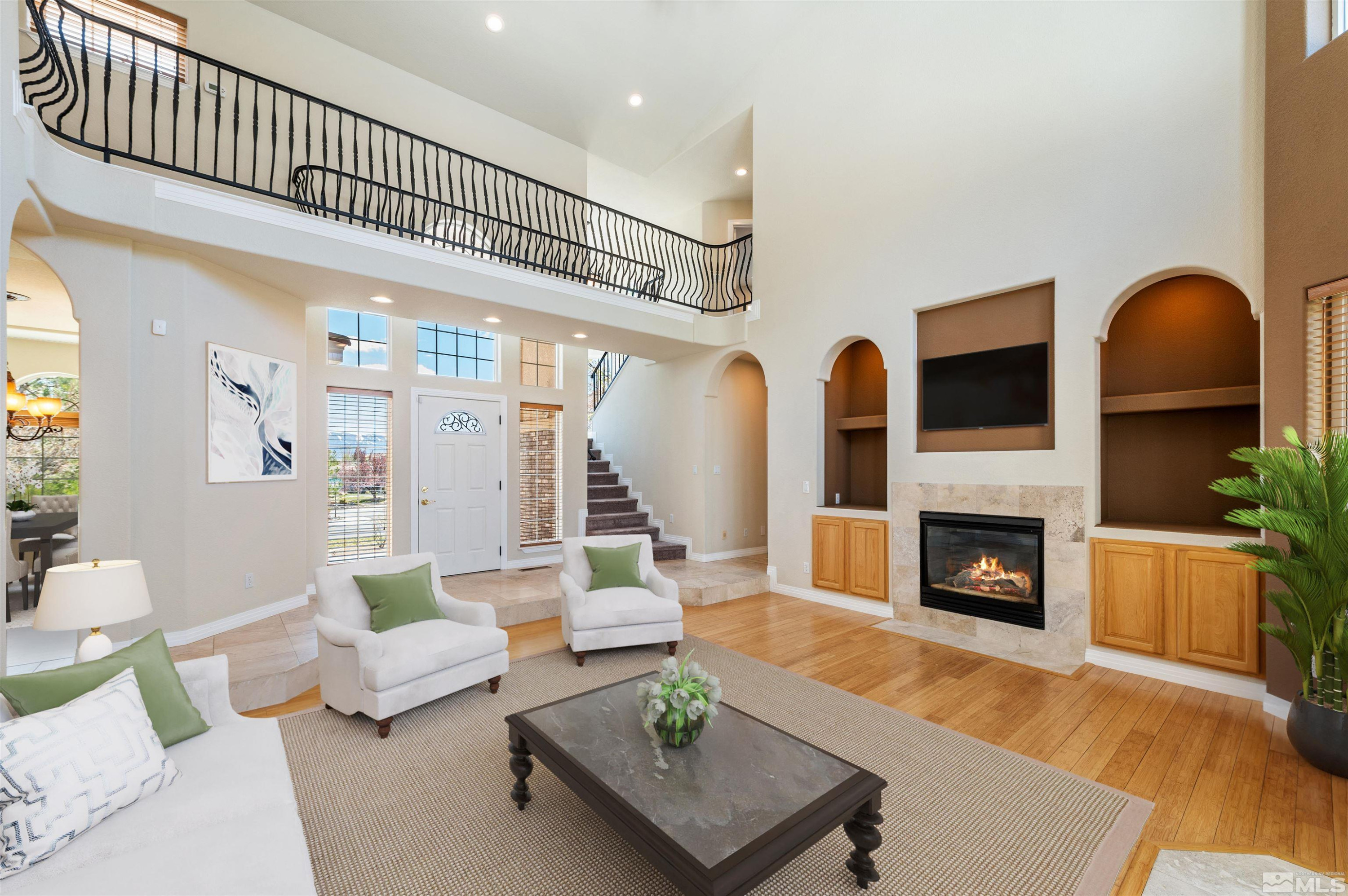 14535 South Quiet Reno, NV 89511 - Photo 4 of 40 a living room with furniture a fireplace and a floor to ceiling window