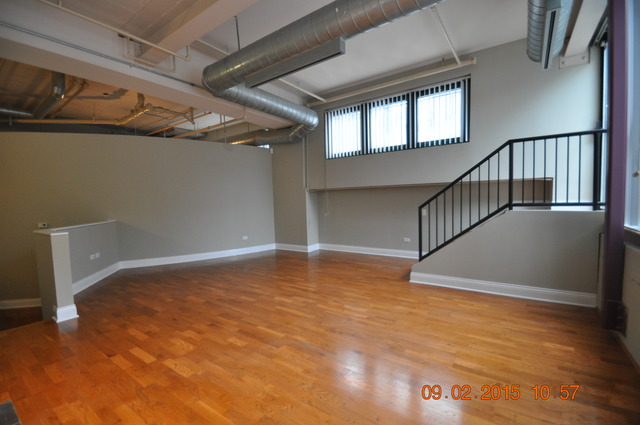 1727 South Indiana Avenue, Unit 26 Chicago, IL 60616 - Photo 2 of 10 a view of an empty room with wooden floor