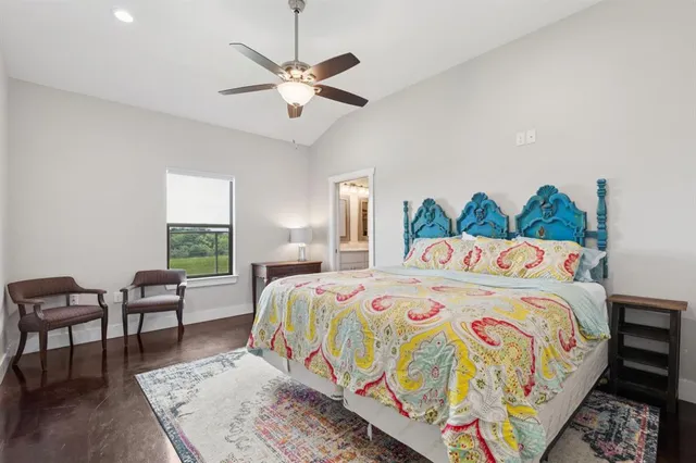 a bedroom with a bed a chandelier and a couch