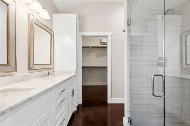 a bathroom with a granite countertop sink mirror and double