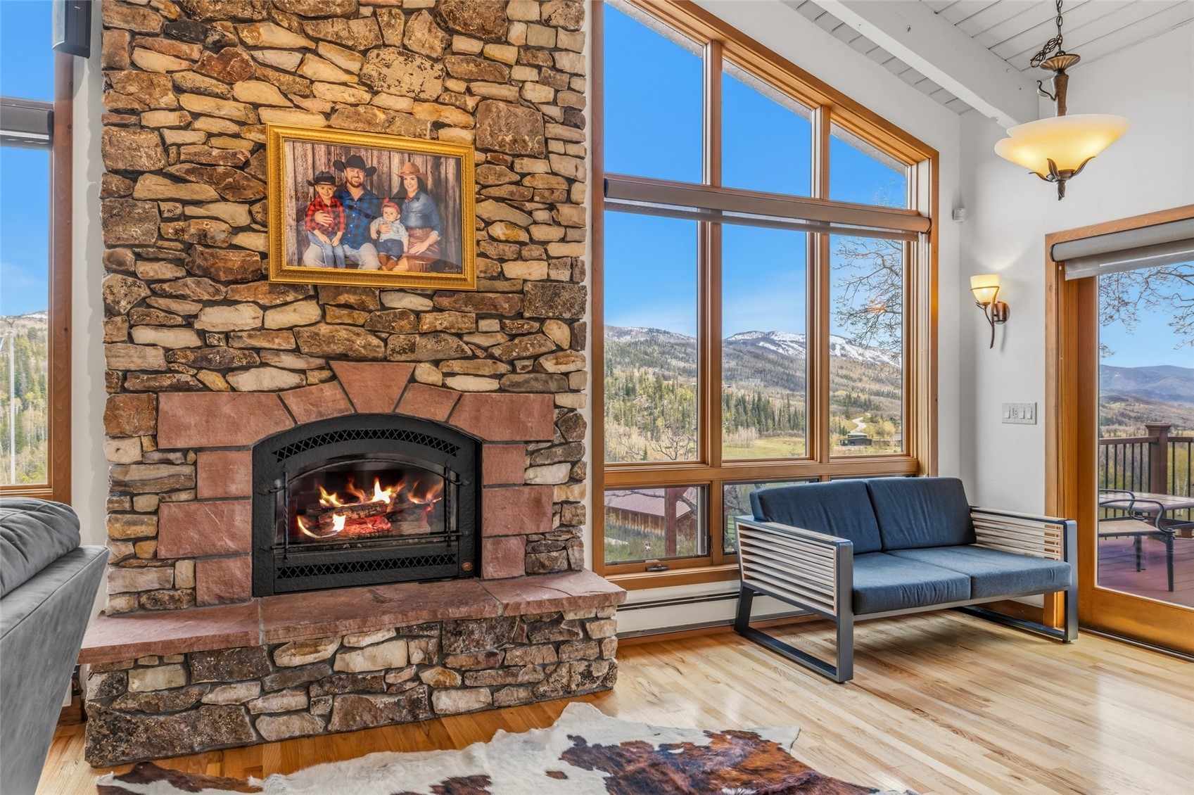 31775 Bradley Ranch Steamboat Springs, CO 80487 - Photo 41 of 49 a living room with furniture a flat screen tv and a fireplace