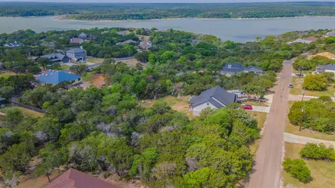 an aerial view of a house with a garden and lake view