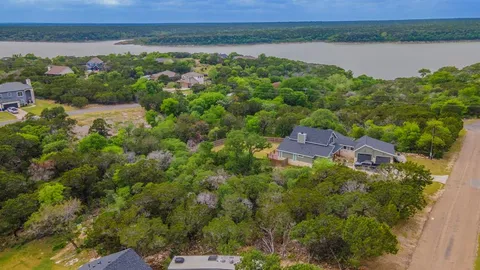 an aerial view of a house with a lake view