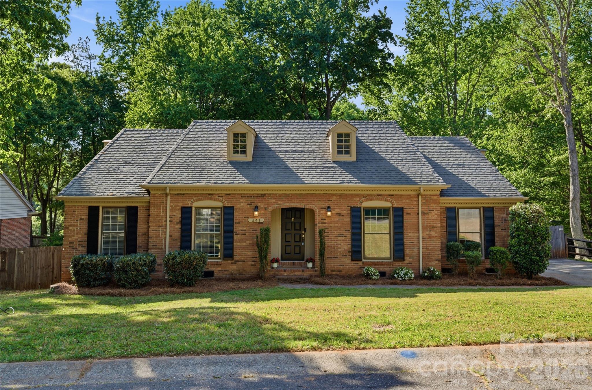 341 Neill Ridge Road Matthews, NC 28105 - Photo 1 of 36 a front view of a house with a garden
