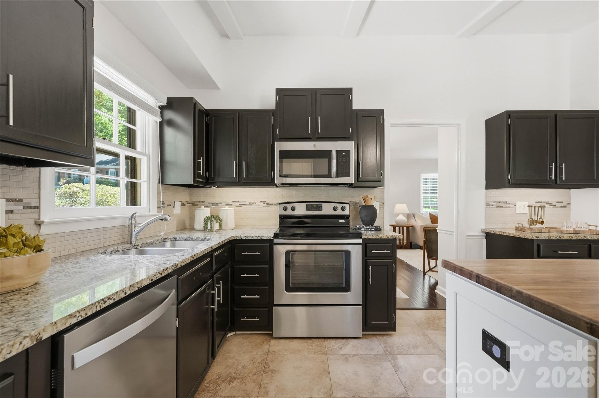 341 Neill Ridge Road Matthews, NC 28105 - Photo 19 of 36 a kitchen with stainless steel appliances granite countertop a stove microwave and sink