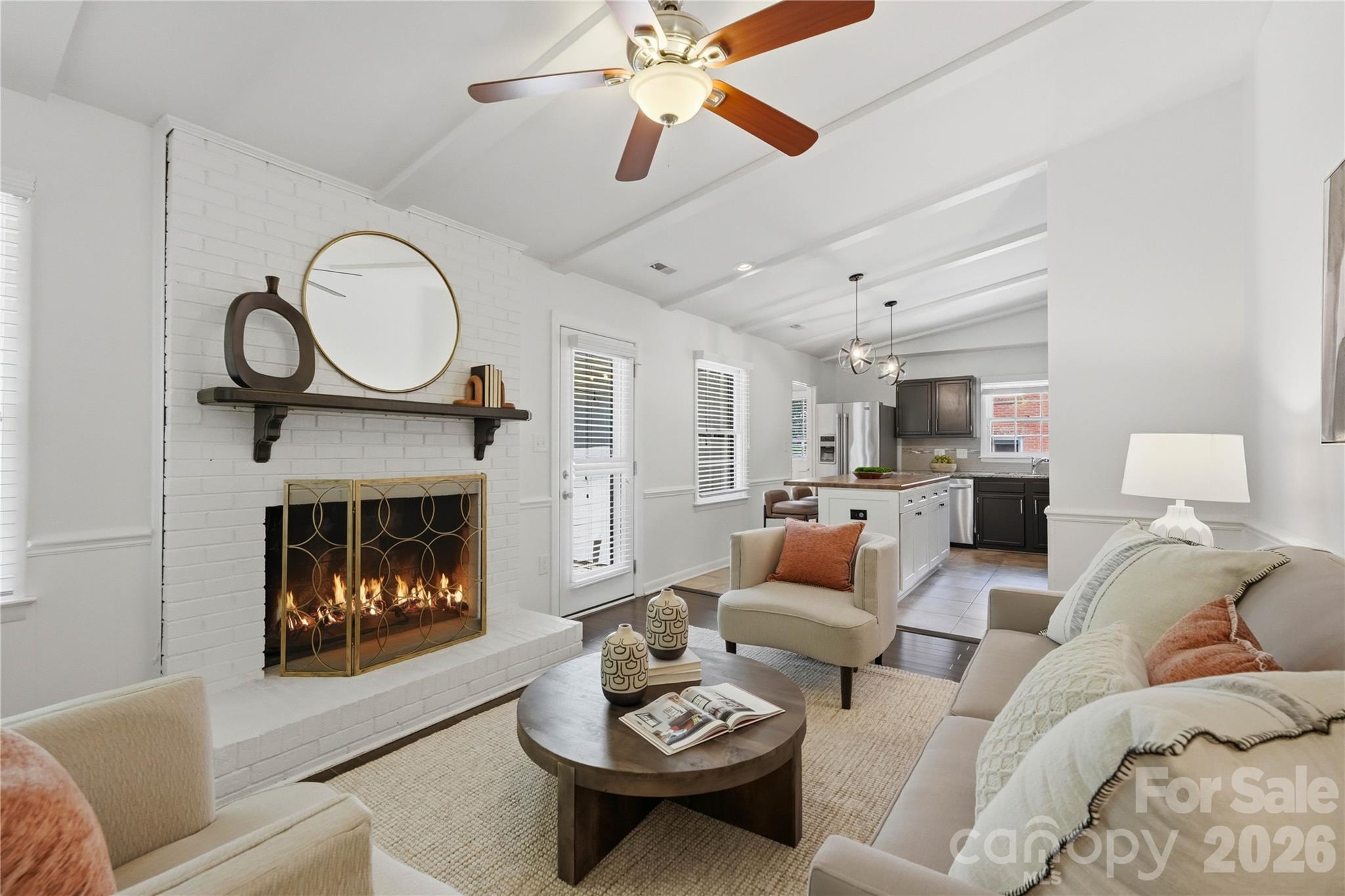 341 Neill Ridge Road Matthews, NC 28105 - Photo 23 of 36 a living room with furniture a fireplace and a chandelier