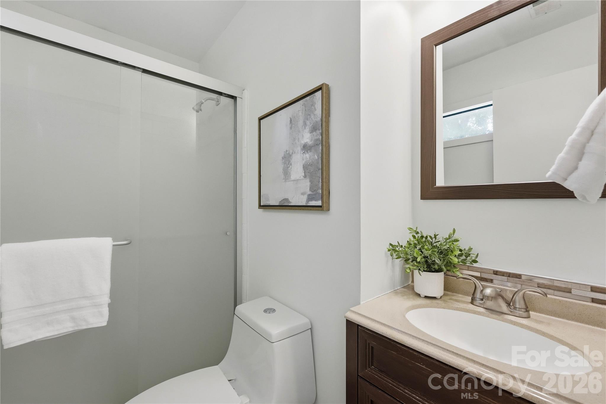341 Neill Ridge Road Matthews, NC 28105 - Photo 27 of 36 a bathroom with a granite countertop sink a mirror and a toilet
