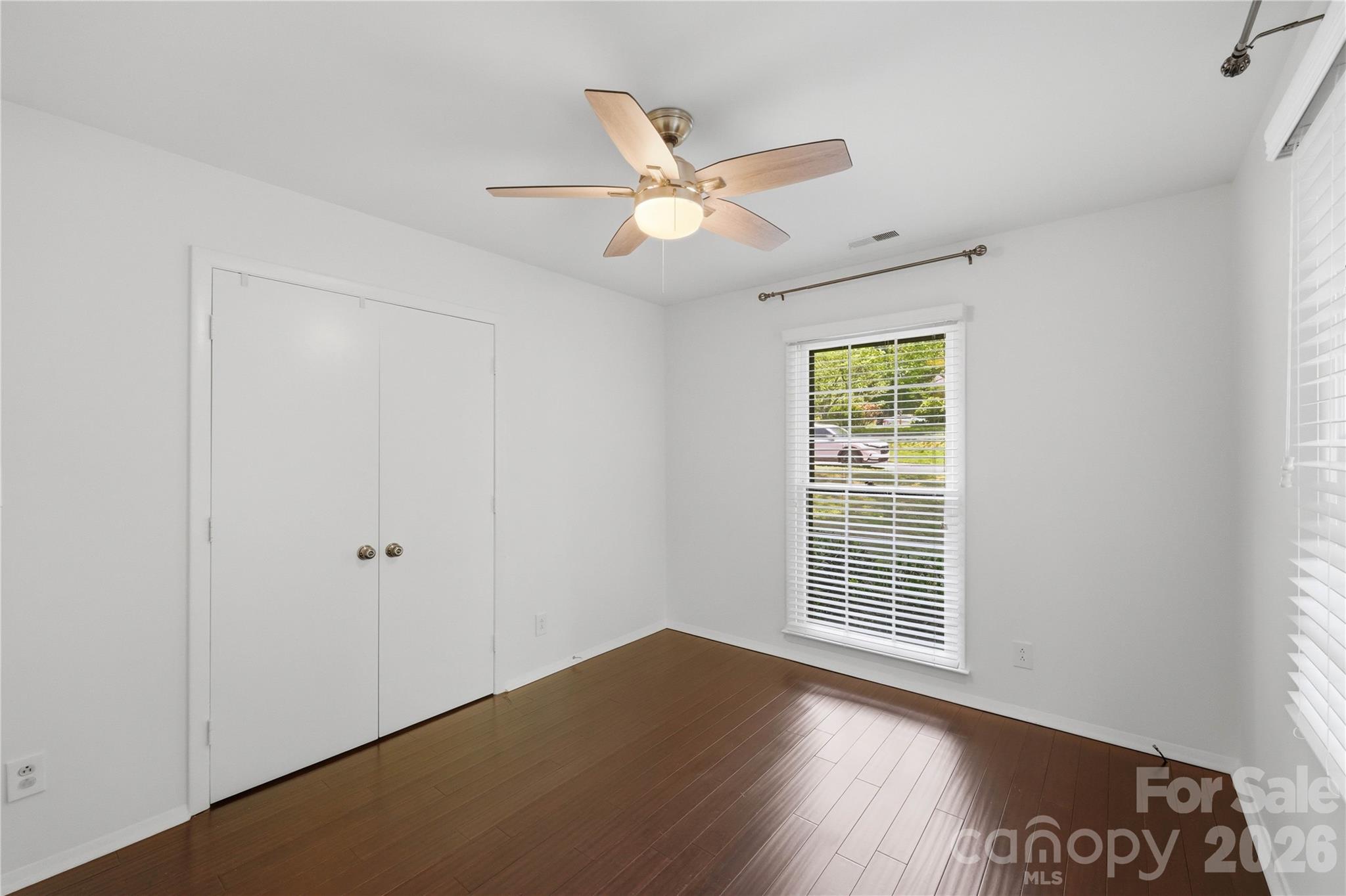 341 Neill Ridge Road Matthews, NC 28105 - Photo 30 of 36 a view of an empty room with wooden floor and a window