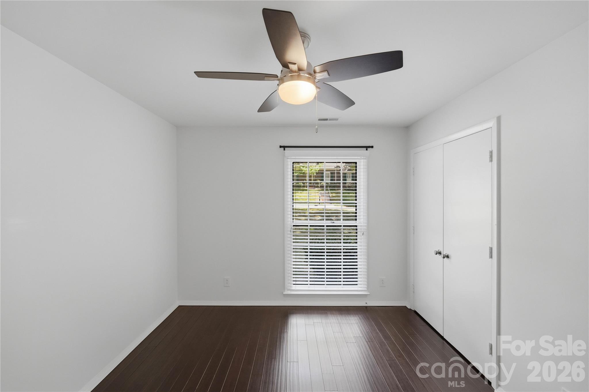 341 Neill Ridge Road Matthews, NC 28105 - Photo 32 of 36 an empty room with wooden floor fan and windows