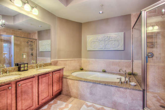 1653 West County Highway 30A, Unit 1116 Santa Rosa Beach, FL 32459 - Photo 16 of 41 a bathroom with a granite countertop tub sink and mirror