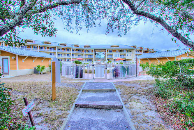 1653 West County Highway 30A, Unit 1116 Santa Rosa Beach, FL 32459 - Photo 32 of 41 a front view of a house with a yard and potted plants