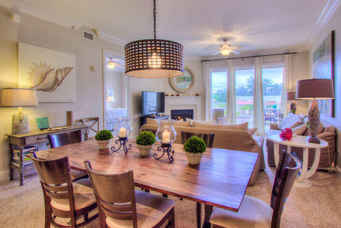 1653 West County Highway 30A, Unit 1116 Santa Rosa Beach, FL 32459 - Photo 9 of 41 a view of a dining room and livingroom with furniture wooden floor a rug a chandelier and a view