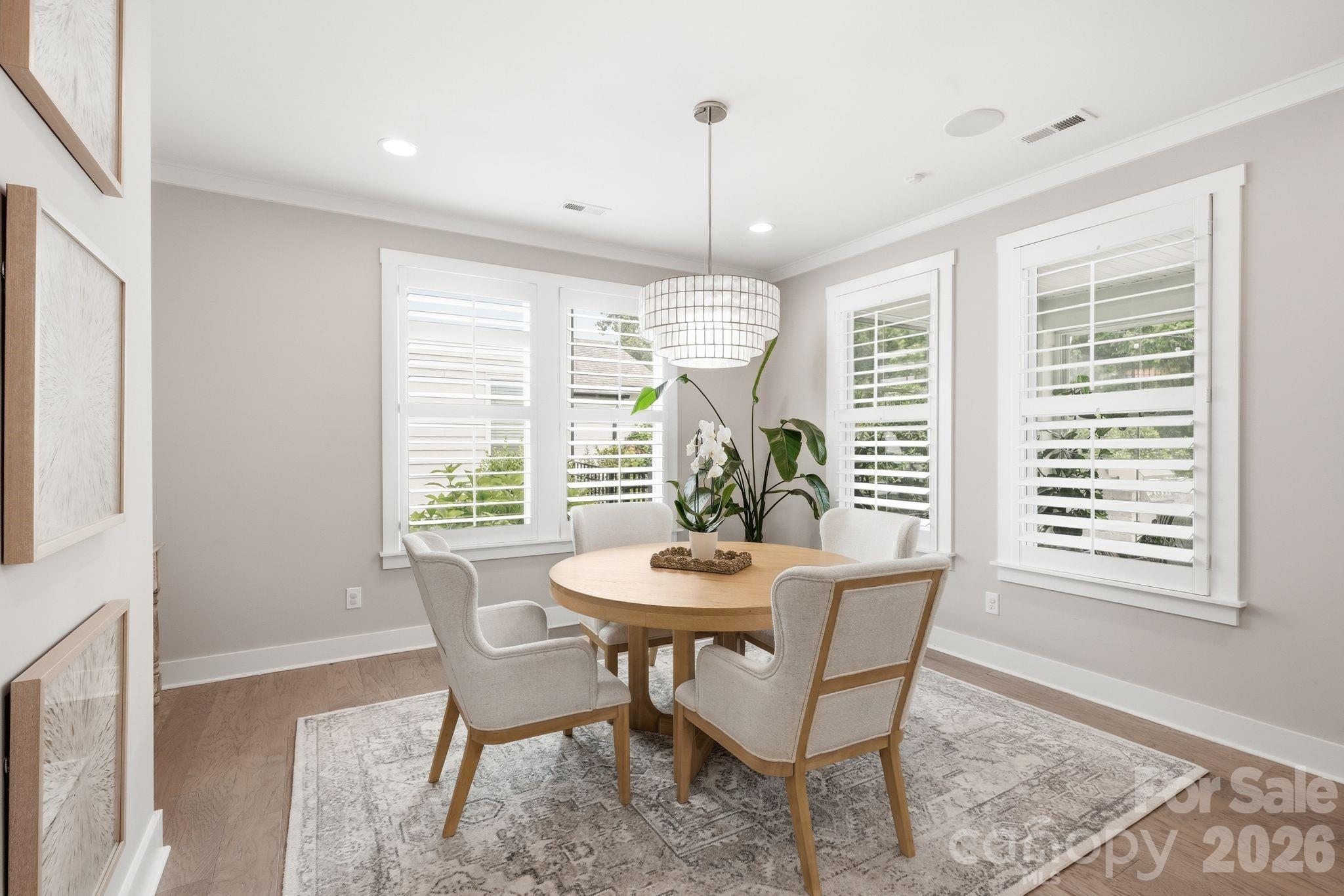 1086 Weir Court Fort Mill, SC 29708 - Photo 11 of 40 a dining room with furniture a chandelier and wooden floor