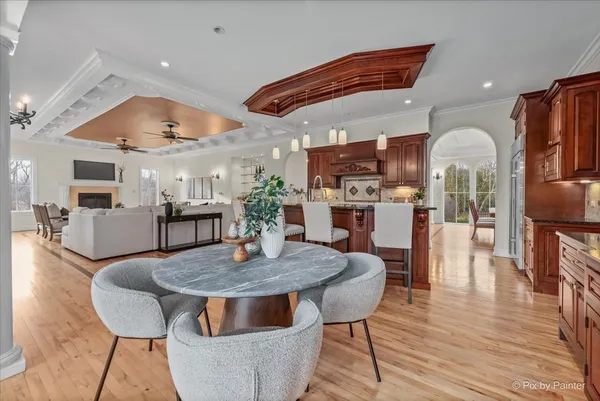 a living room with furniture a fireplace and a chandelier