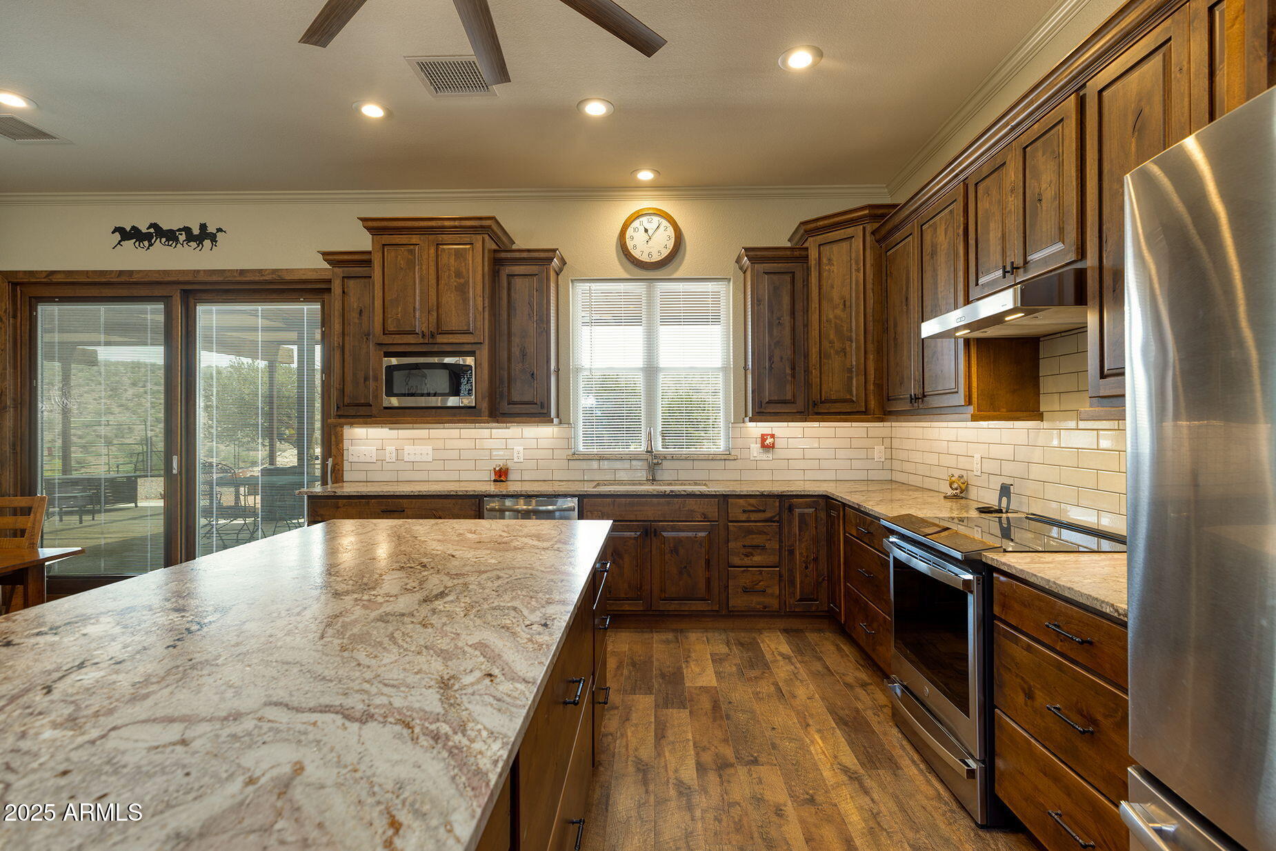 828 North Gun Creek Road Payson, AZ 85541 - Photo 16 of 57 a large kitchen with stainless steel appliances granite countertop a stove a sink and a microwave