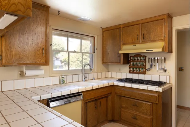 a kitchen with a sink and cabinets
