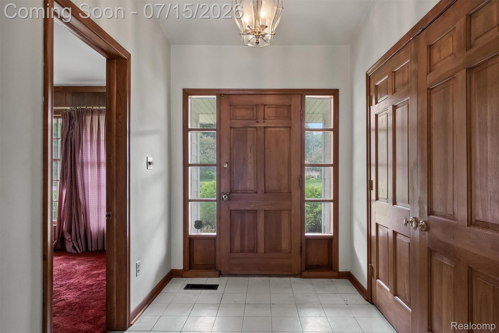 1151 Peveril Road Bloomfield Hills, MI 48304 - Photo 5 of 39 Entryway featuring a solid wood-panel front door and a large double-doored coat closet