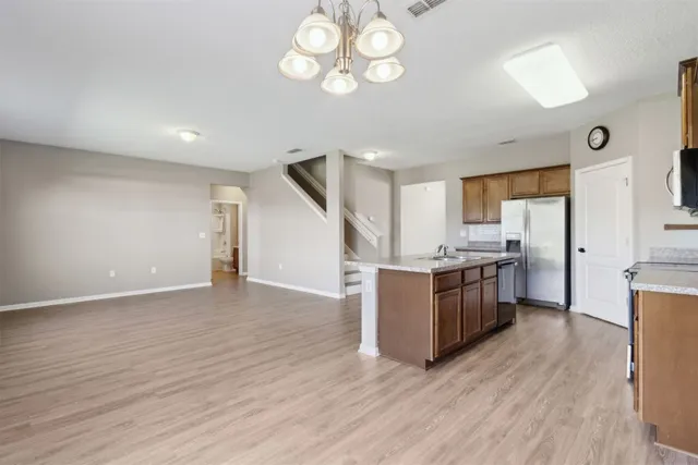 a kitchen with stainless steel appliances granite countertop a sink stove and refrigerator