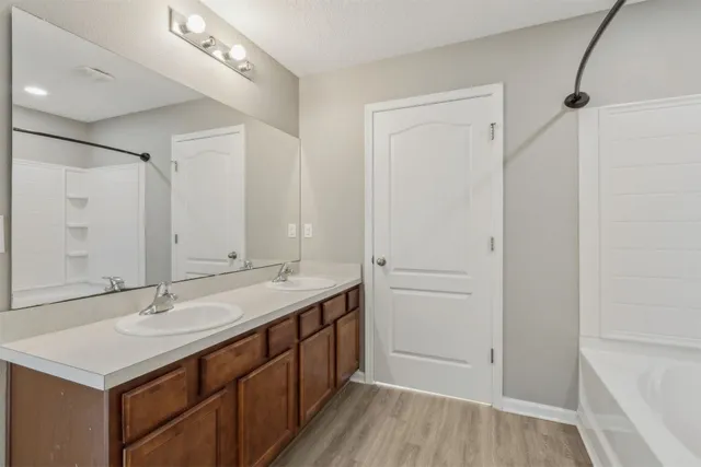a view of an empty walk in closet with wooden floor
