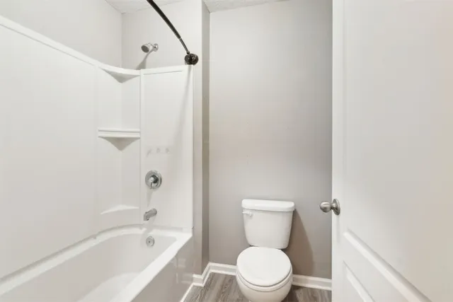 an empty room with a window and a ceiling fan