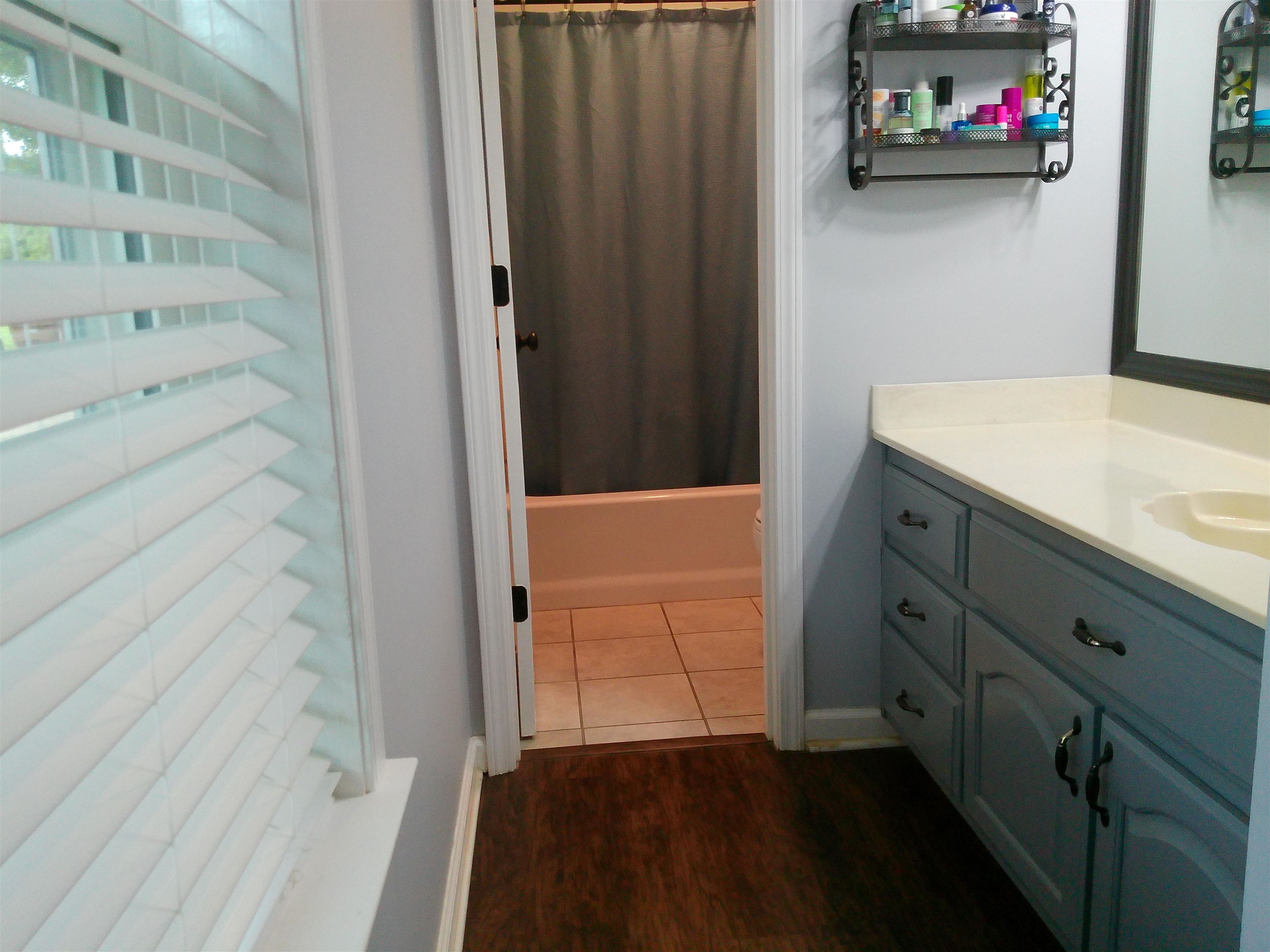 336 Pwr Loop Munford, TN 38058 - Photo 19 of 24 Bathroom with vanity, hardwood / wood-style flooring, and shower / bath combo