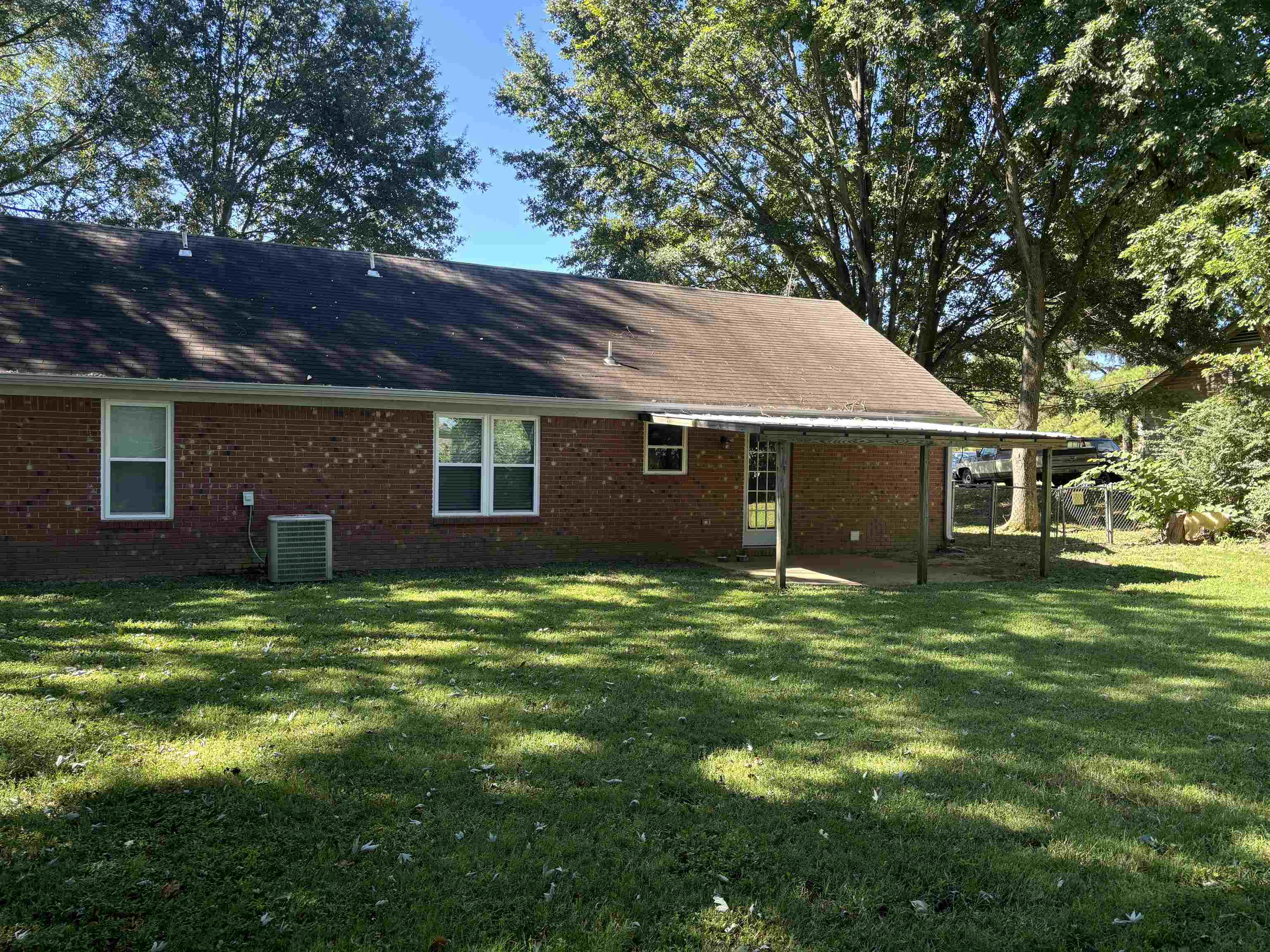 336 Pwr Loop Munford, TN 38058 - Photo 21 of 24 Back of house with a lawn, a patio area, and central AC unit