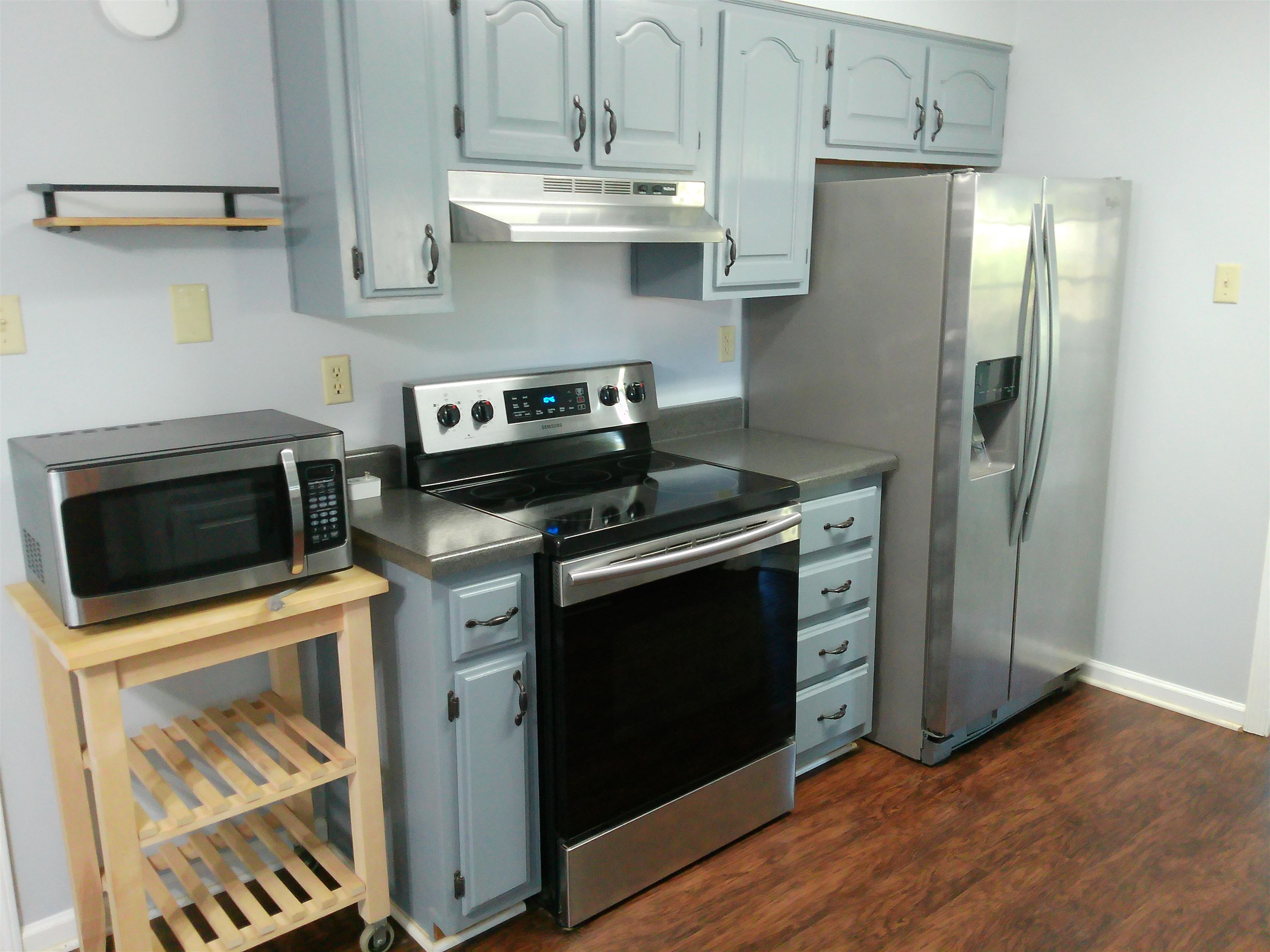 336 Pwr Loop Munford, TN 38058 - Photo 6 of 24 Kitchen featuring stainless steel appliances, dark wood-type flooring, and range hood