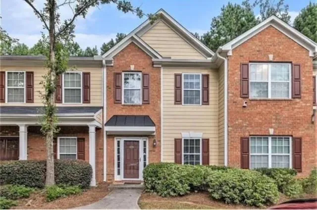 front view of brick house with a yard
