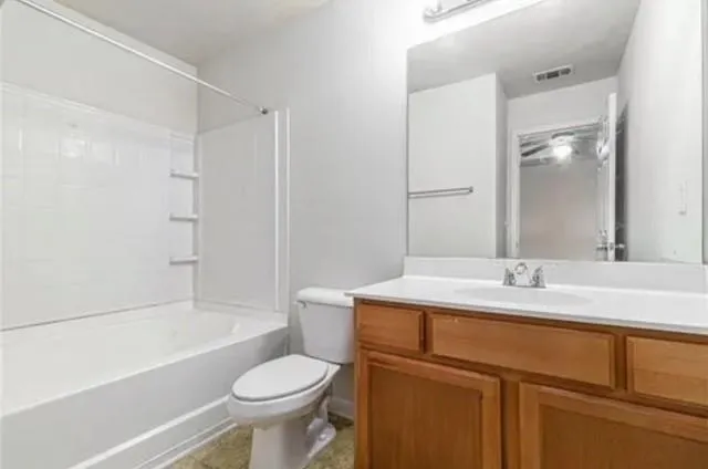 a bathroom with a sink toilet vanity and shower