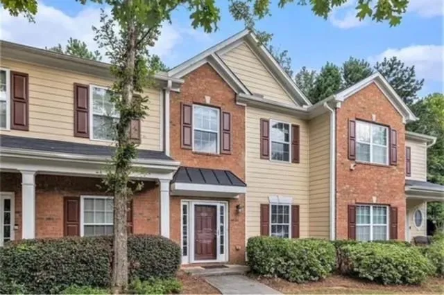 front view of brick house with a yard