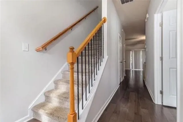 a view of a hallway with wooden floor and entryway