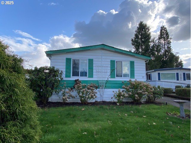 1125 58th Street, Unit 77 Springfield, OR 97478 - Photo 1 of 22 a front view of a house with garden