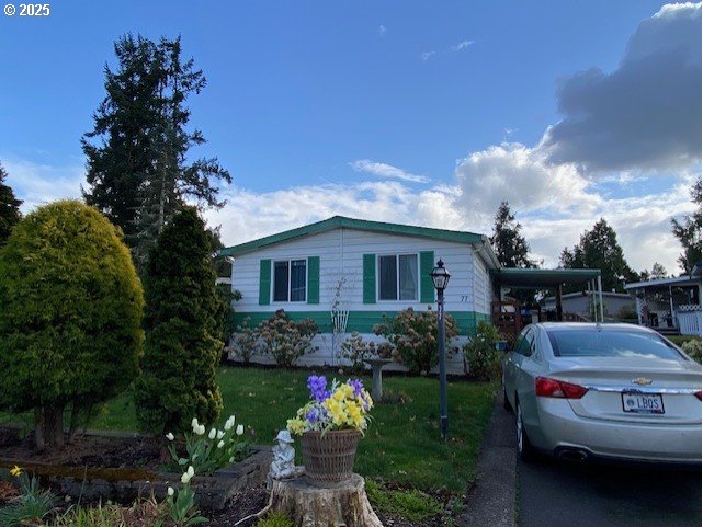 1125 58th Street, Unit 77 Springfield, OR 97478 - Photo 3 of 22 a front view of a house with garden