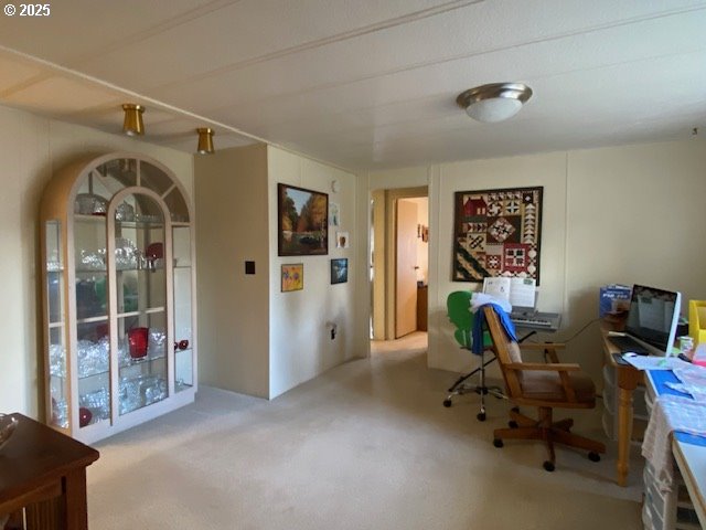 1125 58th Street, Unit 77 Springfield, OR 97478 - Photo 6 of 22 a view of a workspace with furniture and entryway