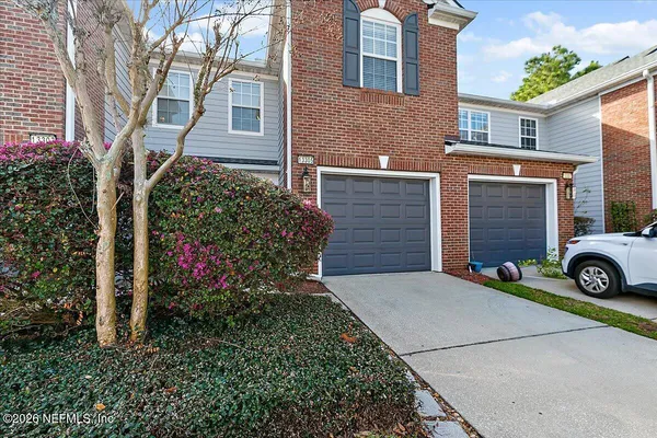 a view of a house with a yard and garage