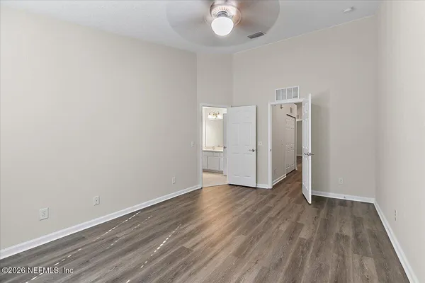a view of an empty room with wooden floor