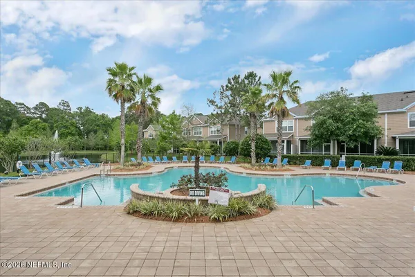 a view of a swimming pool with a yard