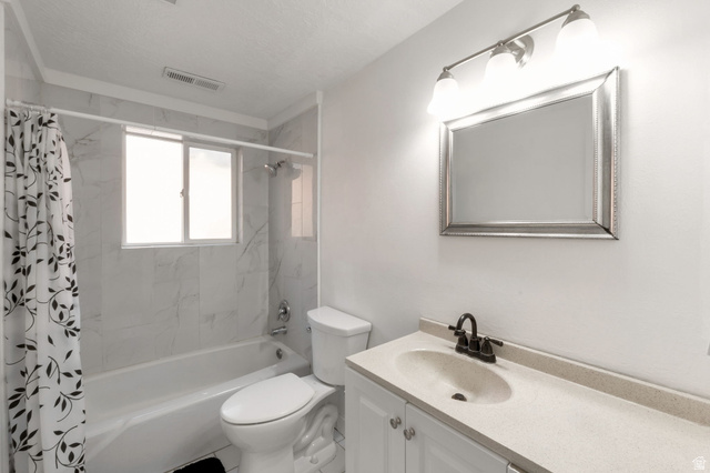 434 South 700 West, Unit 2 Provo, UT 84601 - Photo 10 of 15 Bathroom featuring a tub/shower combination with white tile surround, a window, and a vanity with an integrated sink and dark bronze faucet