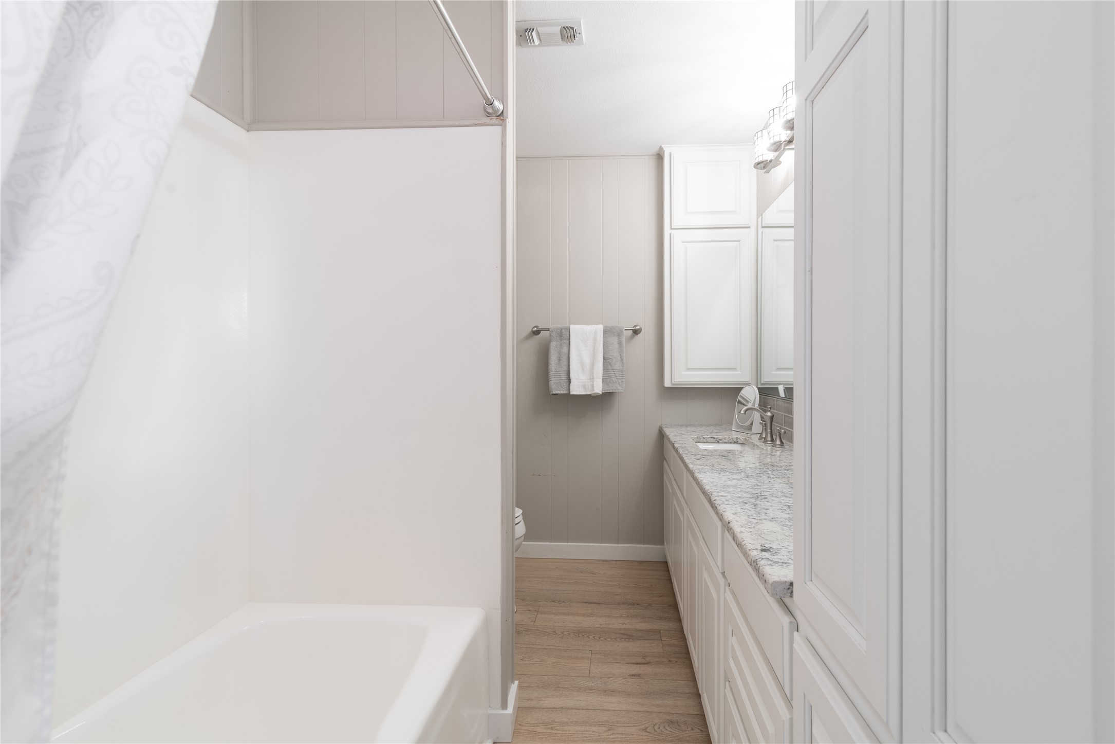 3807 Boat Dock Road Lago Vista, TX 78645 - Photo 17 of 37 A pristine bathroom featuring a combined shower and tub, complemented by an extensive vanity.