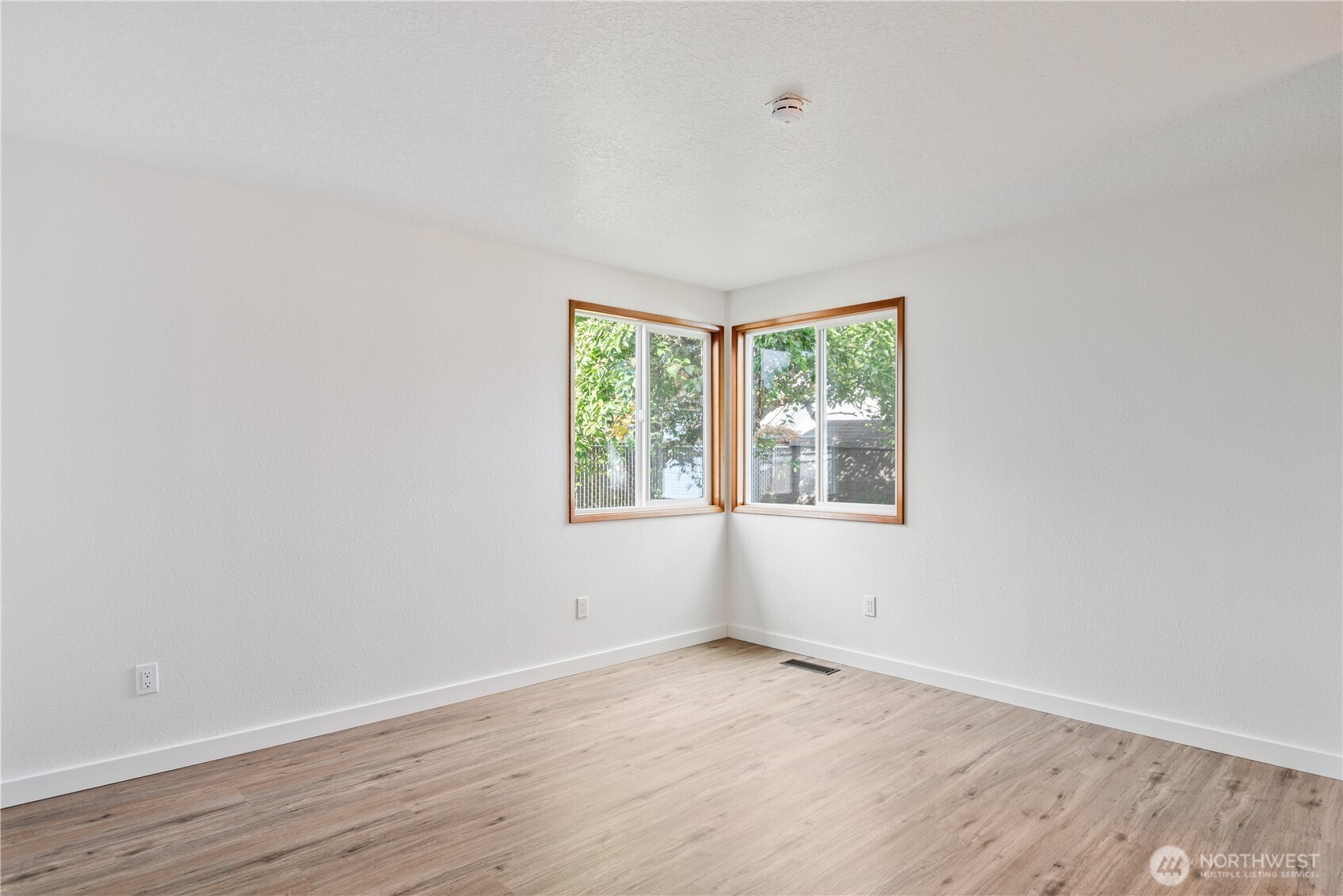 2421 Hickory Avenue Longview, WA 98632 - Photo 12 of 26 an empty room with wooden floor and windows