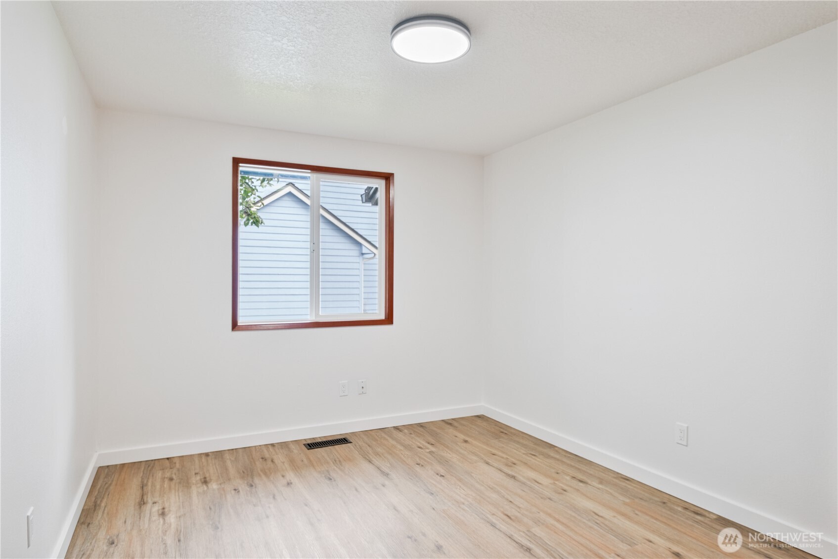 2421 Hickory Avenue Longview, WA 98632 - Photo 16 of 26 an empty room with wooden floor and windows