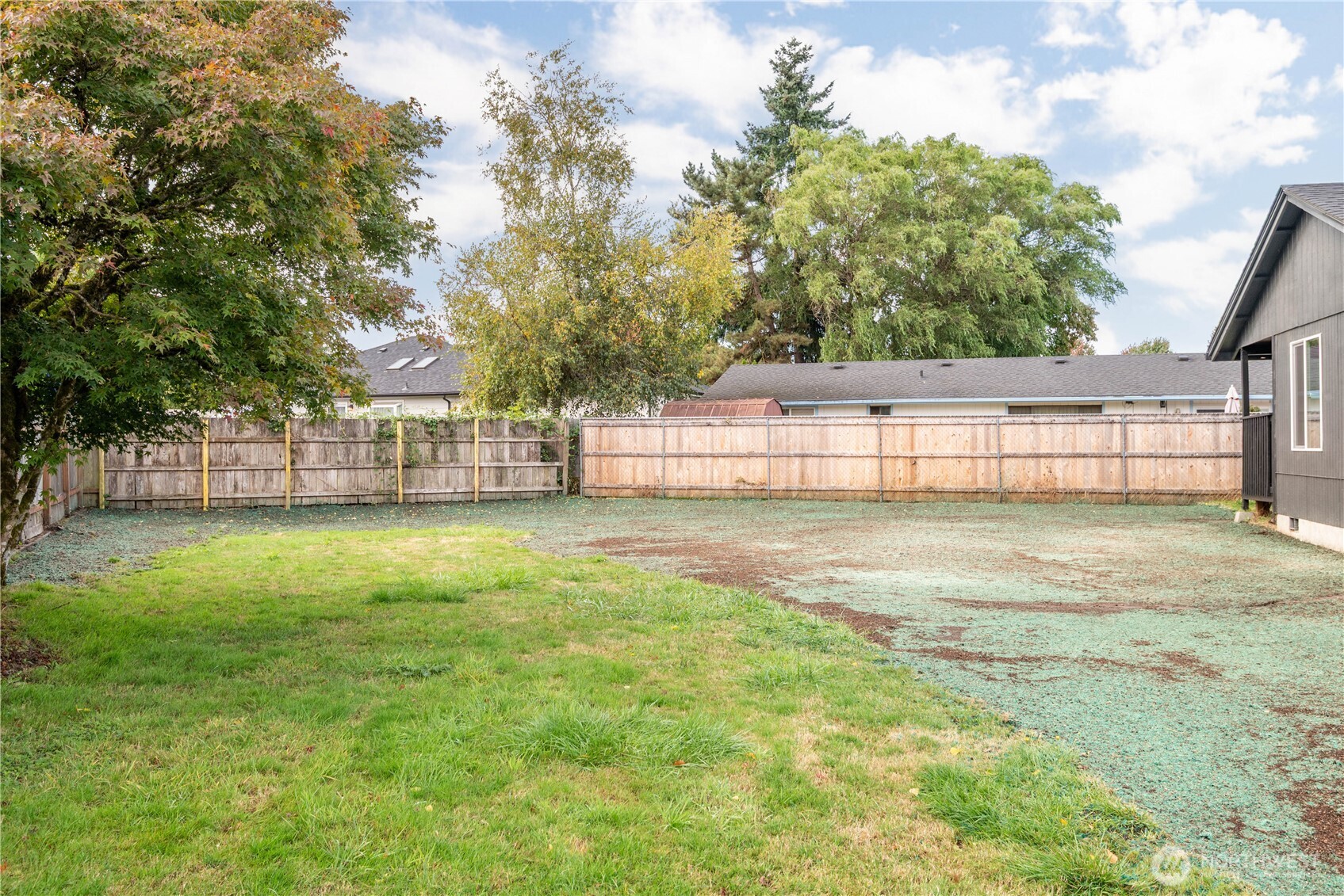 2421 Hickory Avenue Longview, WA 98632 - Photo 23 of 26 a view of backyard with large trees and wooden fence