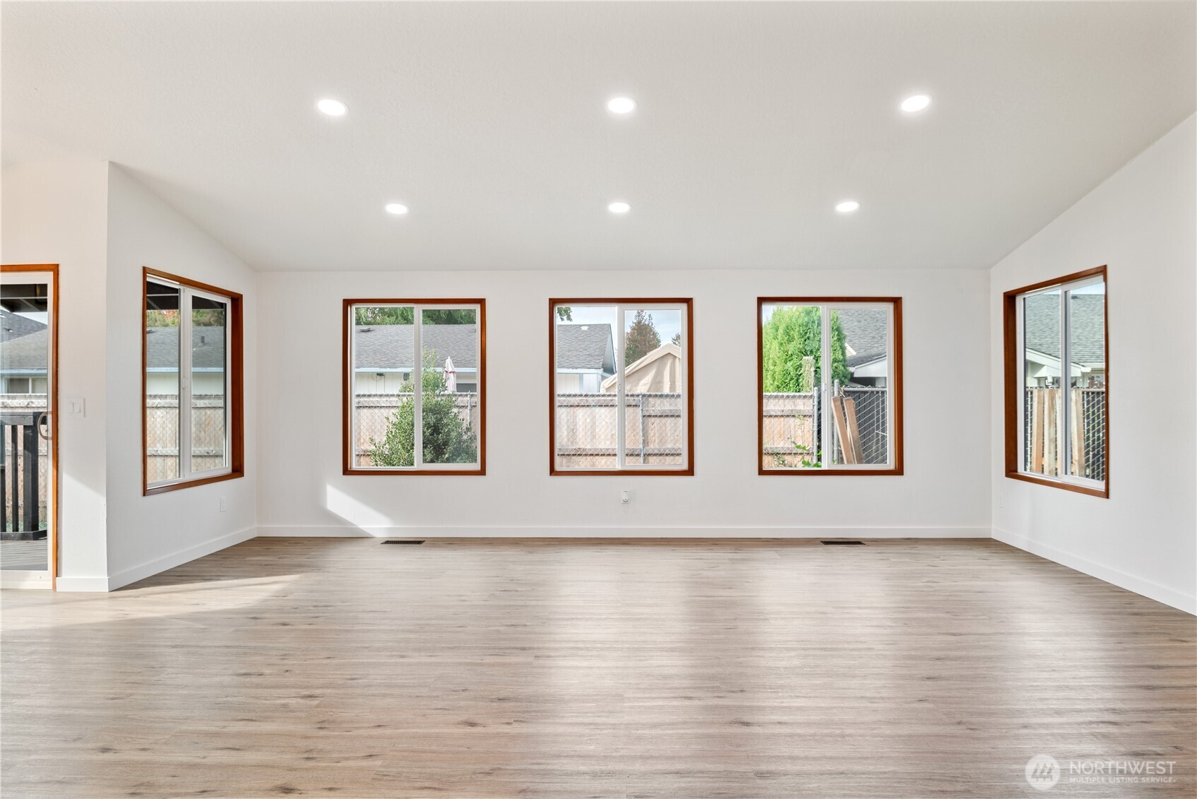 2421 Hickory Avenue Longview, WA 98632 - Photo 4 of 26 a view of an empty room with wooden floor and windows