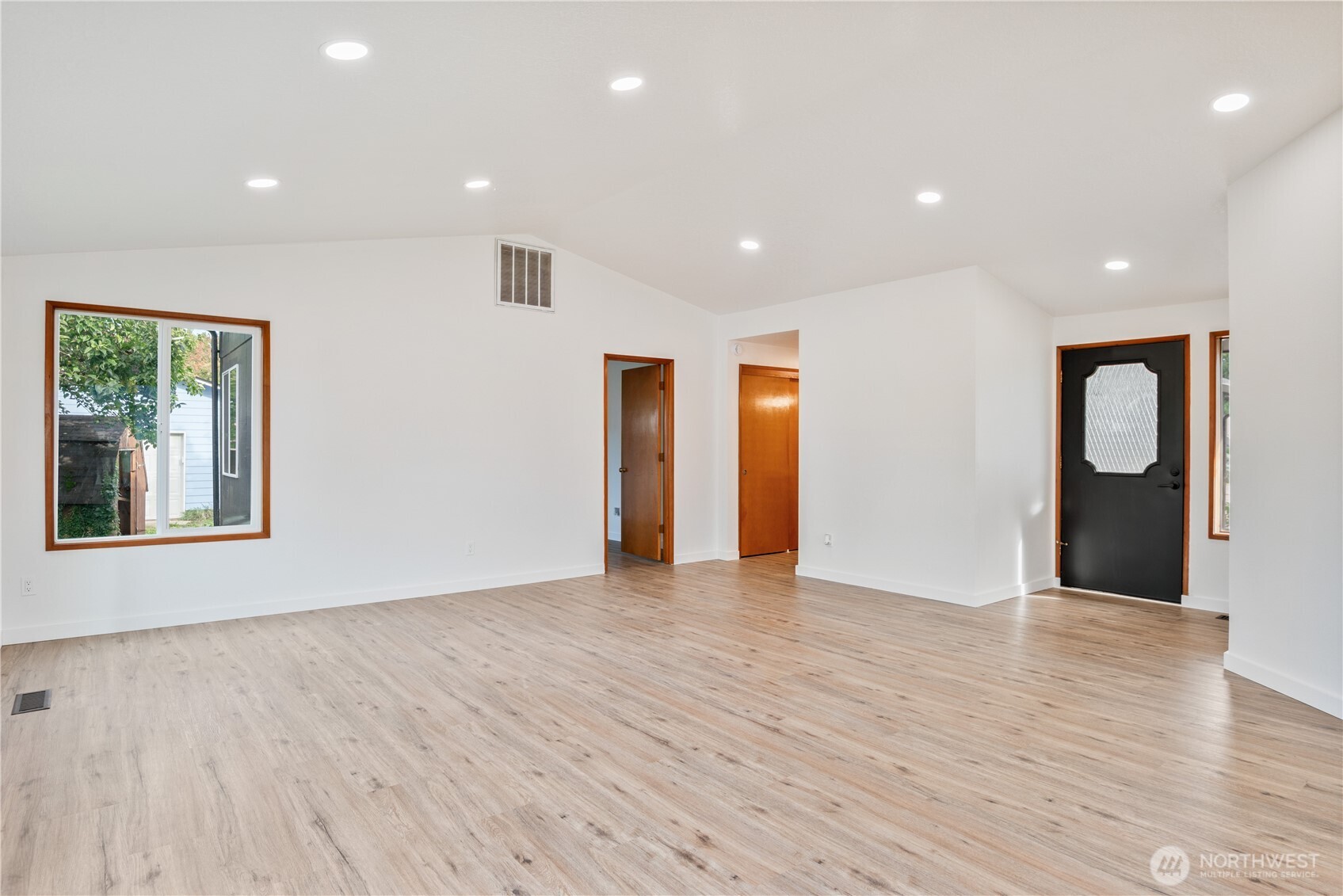 2421 Hickory Avenue Longview, WA 98632 - Photo 5 of 26 a view of an empty room with wooden floor and windows