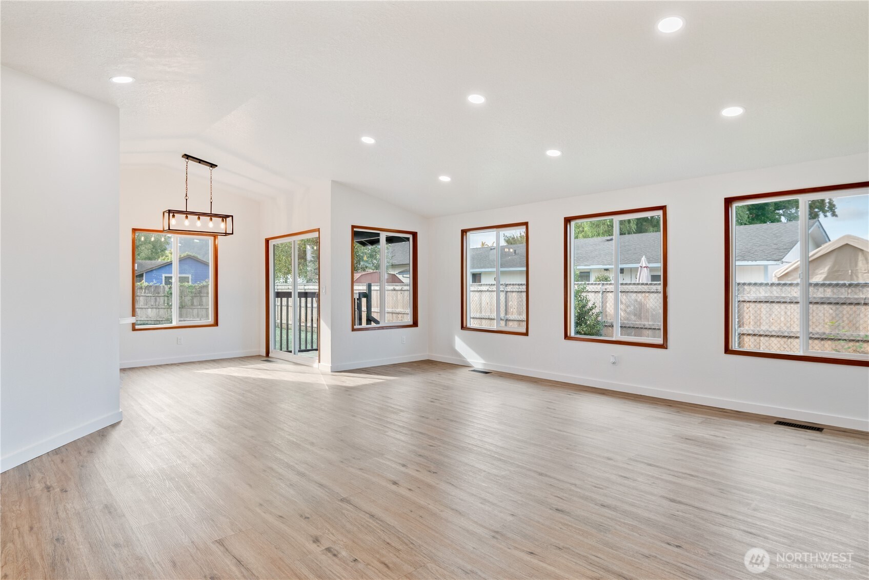 2421 Hickory Avenue Longview, WA 98632 - Photo 6 of 26 a view of an empty room with a window and wooden floor