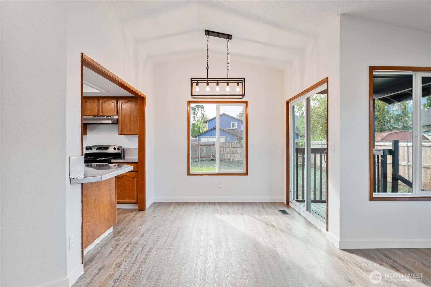 2421 Hickory Avenue Longview, WA 98632 - Photo 8 of 26 a view of a room with wooden floor a ceiling fan and windows