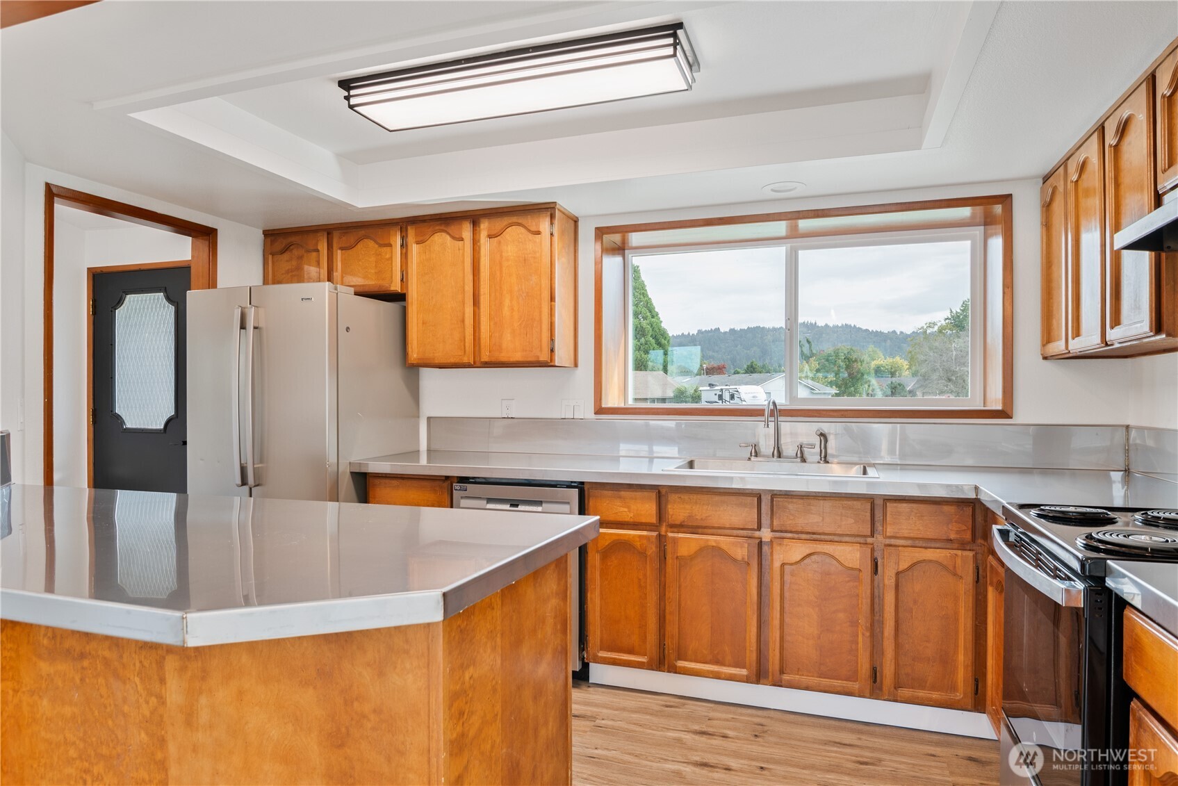 2421 Hickory Avenue Longview, WA 98632 - Photo 9 of 26 a kitchen with stainless steel appliances granite countertop a sink and a stove